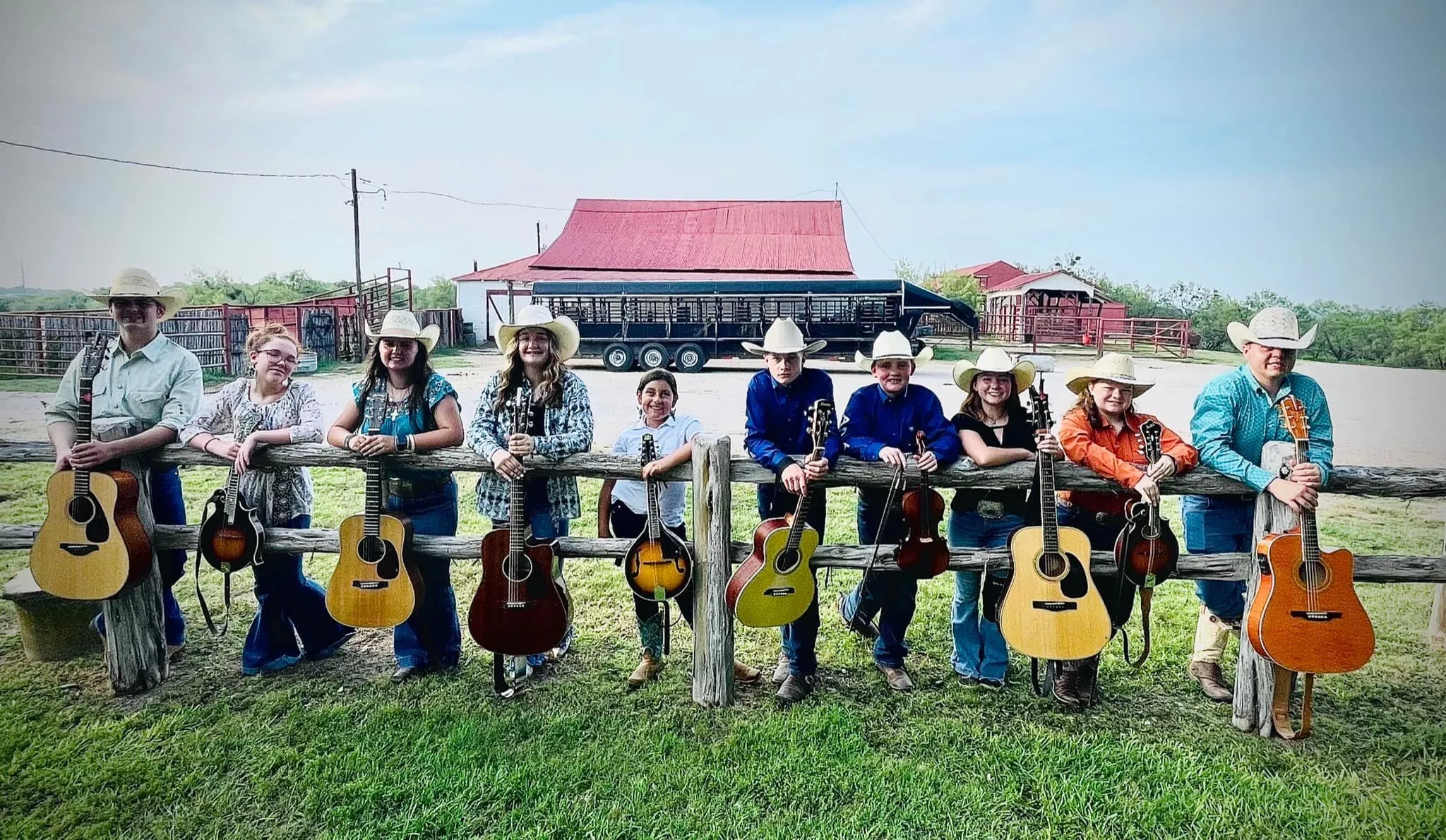 Campers in cowboy hats line up with their guitars at Burson Ranch